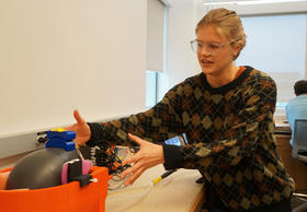 Christie Crandall, a PhD student in mechanical engineering at Wash U, explains how the device will gently vibrate volunteers' heads while they're inside the MRI machine.