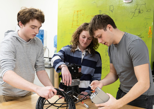 WashU Satellite’s chief mechanical engineer Jack Galloway, chief physicist Sophie Fendler and project manager Geoffrey Goffman work in Urbauer Hall.
