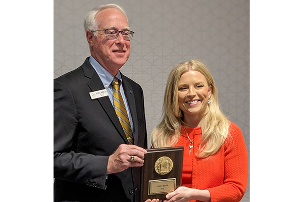 Boyd, right, accepts the award