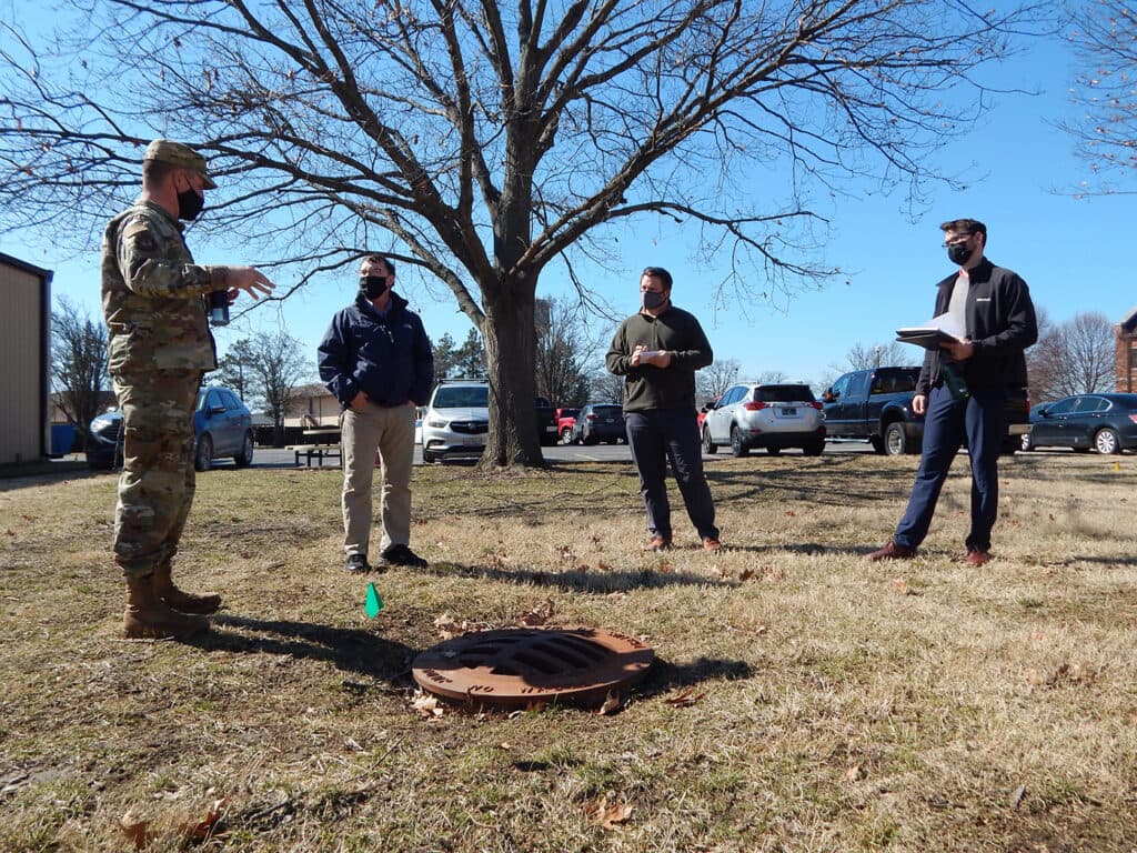 Lt. Col. Paul Fredin and Kenneth Cavanaugh talk with graduate students