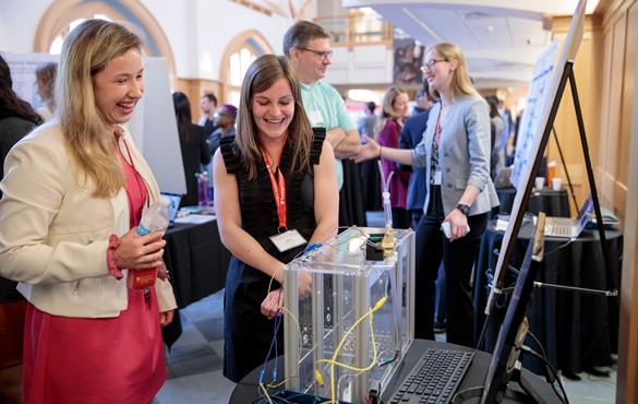 Right: Senior Sara McCutcheon (right) at the 2019 BME Day. Below: Ashton Naumann (left), Matt Heiken (second from left) and Logan Groneck (right) pitch VoltaFeet during the poster