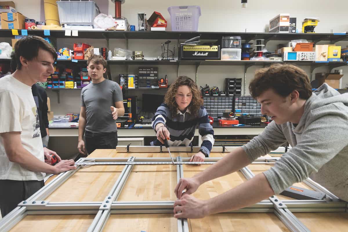 Clockwise from left: Avery Cohen, Geoffrey Goffman, Sophie Fendler and Jack Galloway assemble the ground station frame. Photos by Jerry Naunheim